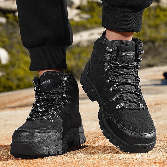 Front view of black hiking boots with dark trousers