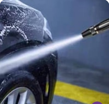 High pressure spray cleaning a car