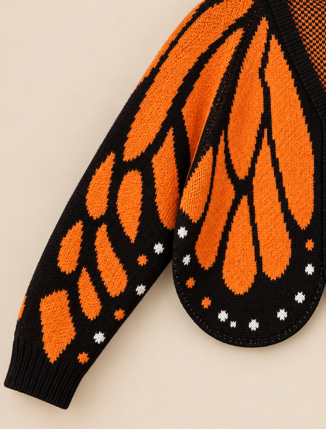 Butterfly wing cardigan sleeve cuff and knit texture detail