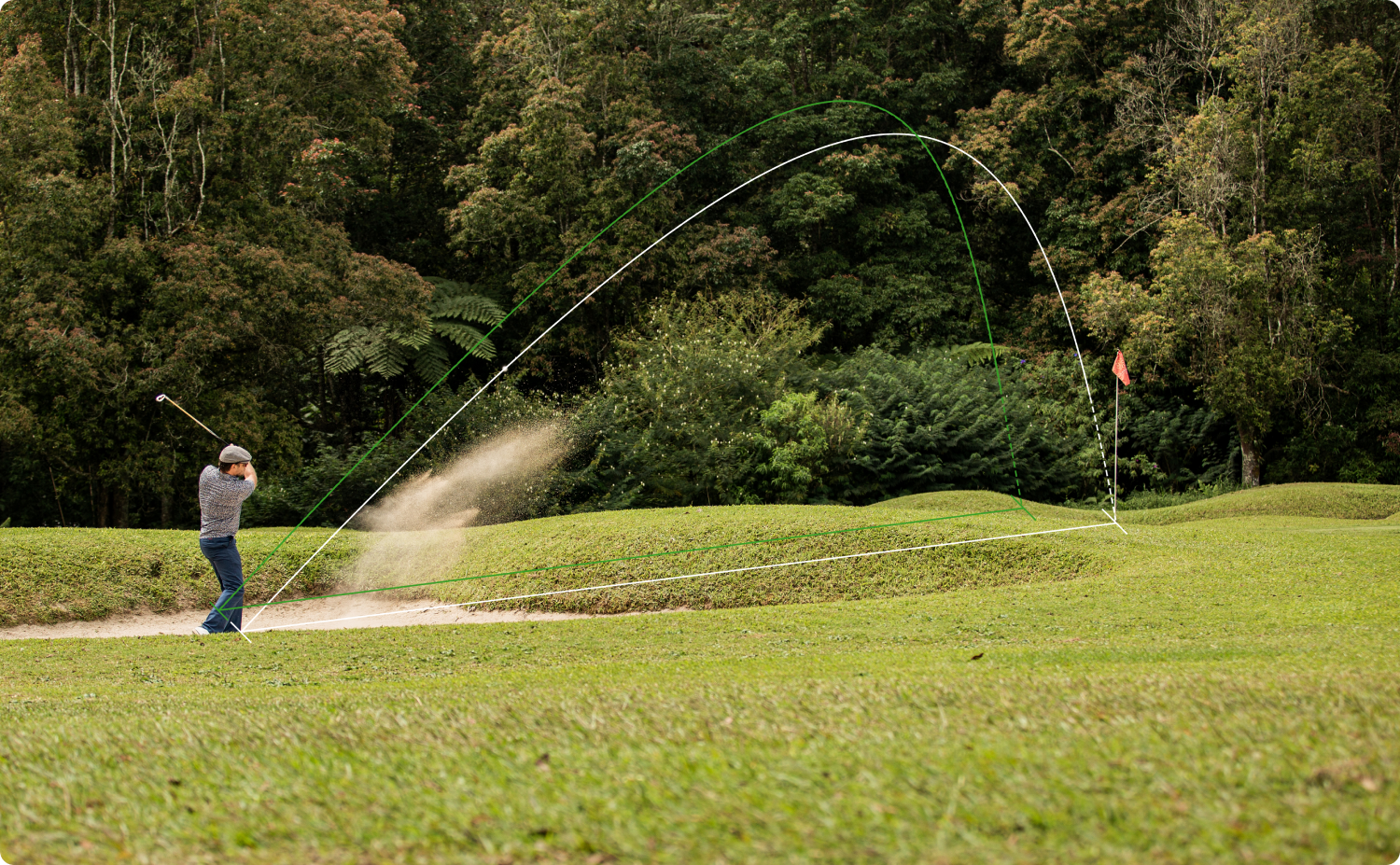The golfer swinging golf club to strike ball from sand trap with trajectory overlays
