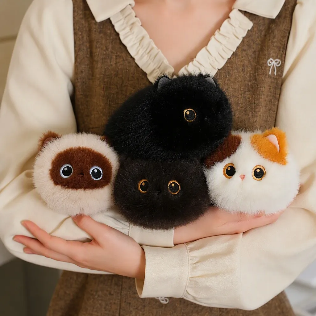 Stress-relief cat bun plush toys in calico, Siamese, brown and black, held in hands
