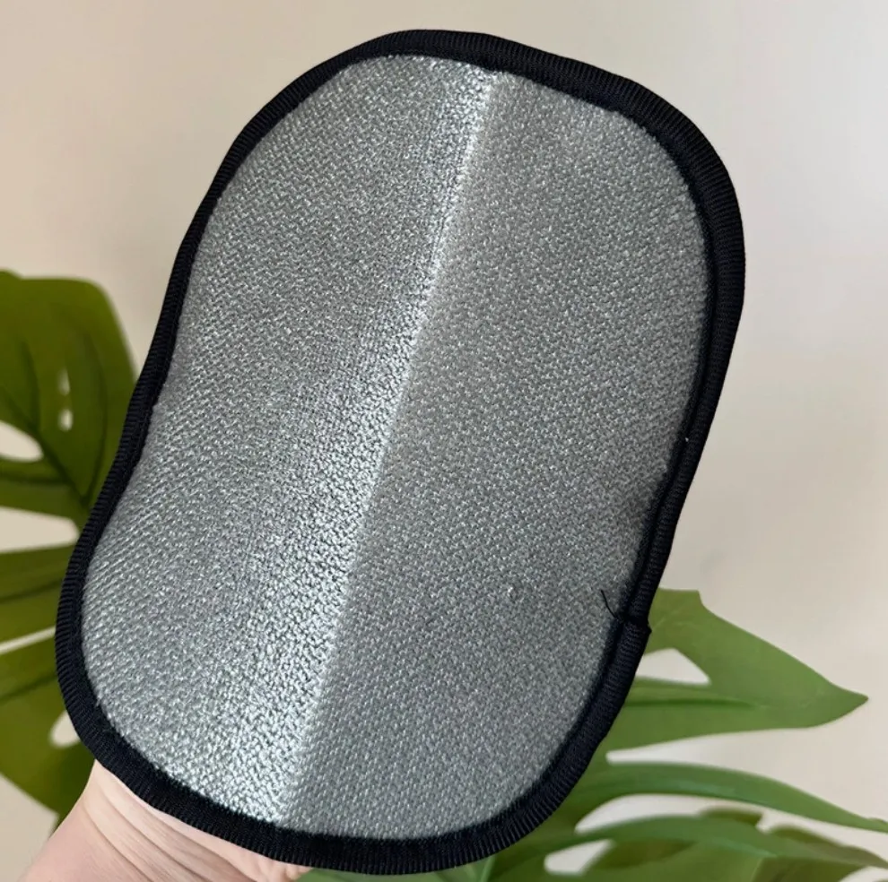 Pet grooming glove product photo with monstera leaf background