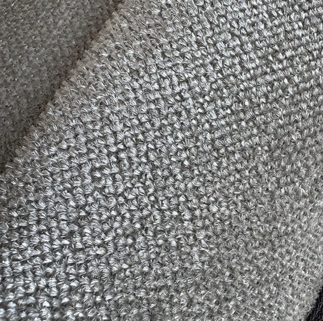 Close-up of silver micro-wire mesh deshedding surface texture