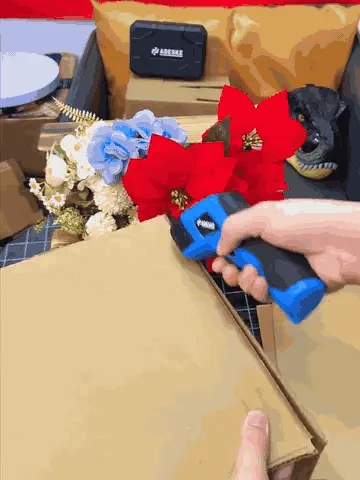 Cordless electric scissors cutting cardboard and carpet