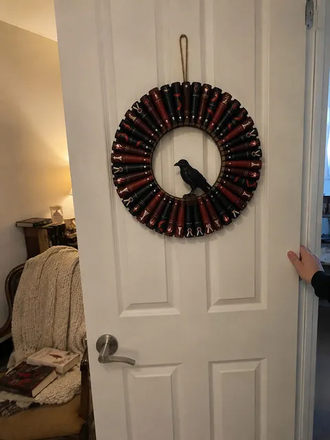 Gothic Raven book wreath on an apartment bedroom door