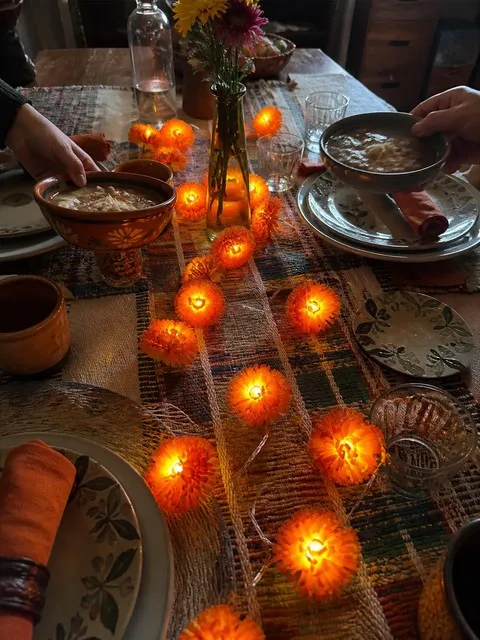 Glowing orange flower lights used as a casual family dinner centerpiece