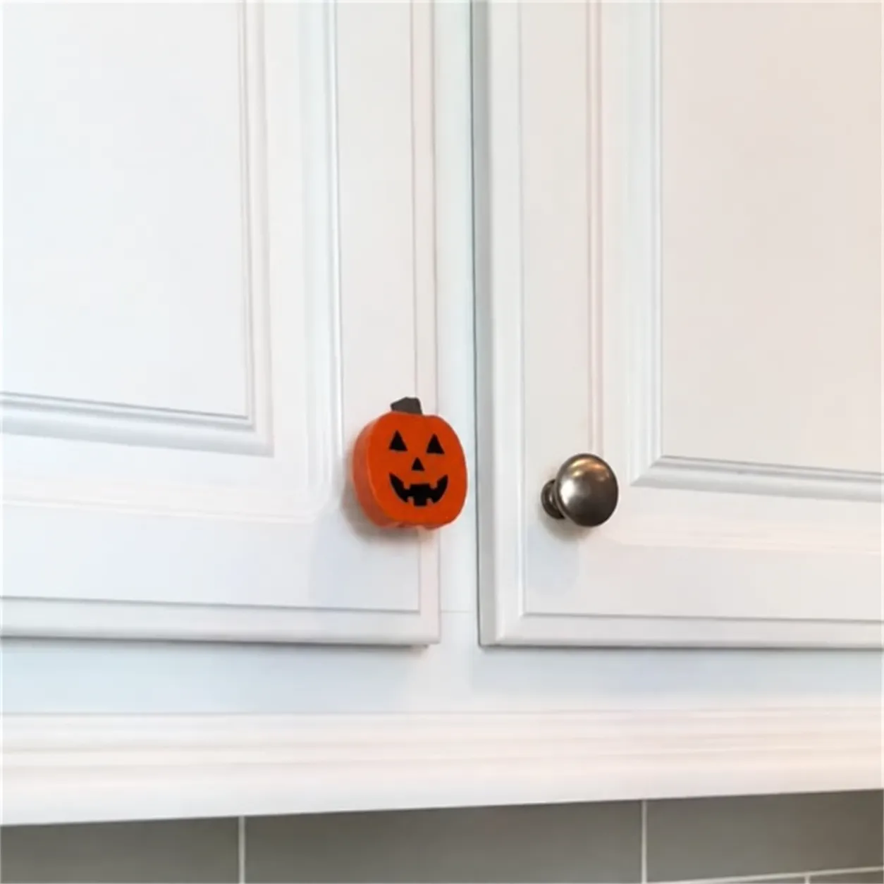 Pumpkin cover installed beside a round cabinet knob