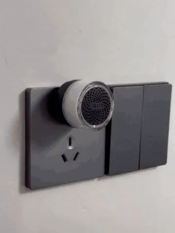 Wireless doorbell button being mounted and pressed while the indoor plug-in chime lights up