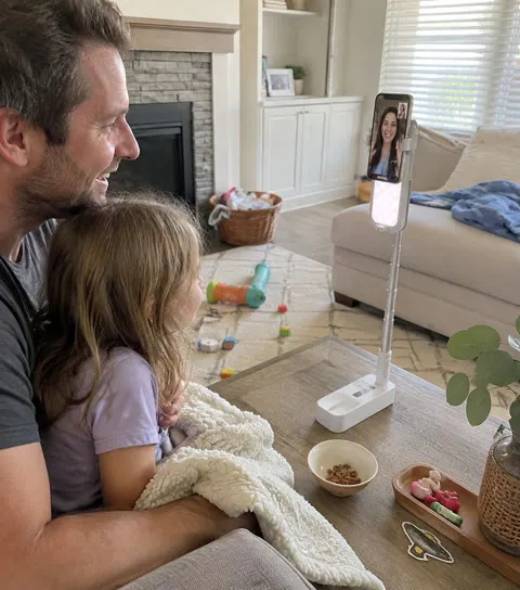 Family using the phone stand for a video call