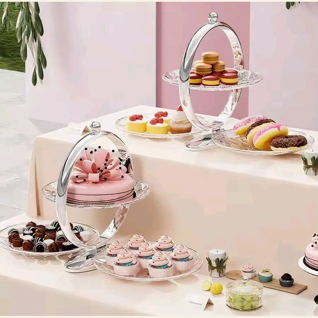 Three-tier serving stands displaying cakes, chocolates, and pastries