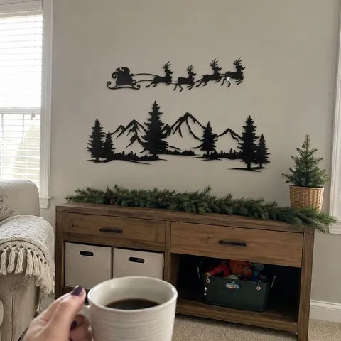 Two-piece black metal Christmas wall art displayed above a family-room sideboard