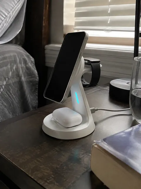 White charging stand on a lived-in bedroom nightstand
