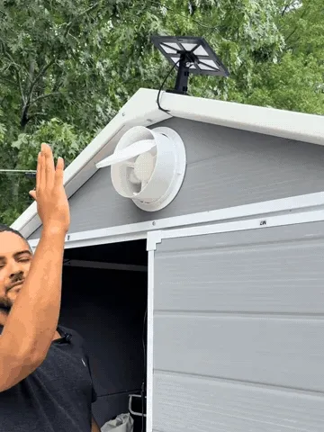 Installing the solar panel and exhaust fan on a backyard shed