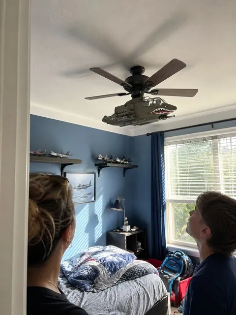 Cobra style ceiling fan attachment in an aviation themed bedroom