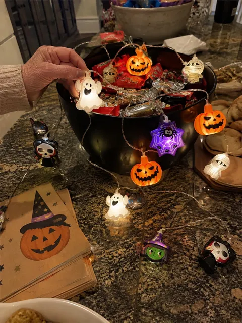 Glowing Halloween lights arranged around a candy bowl