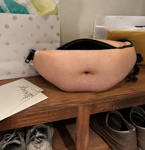 Novelty waist pack beside gift packaging