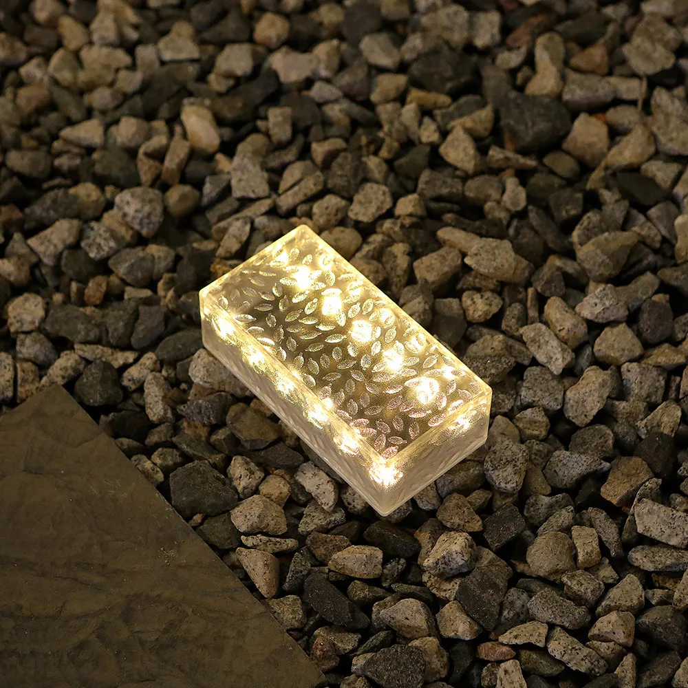 Warm rectangular glass brick light in a gravel garden bed