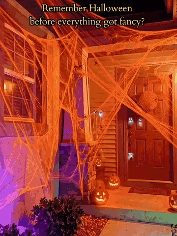 Orange stretchable spider web being arranged across a Halloween porch