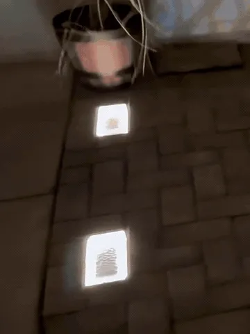 A glass brick light replacing an ordinary patio paver