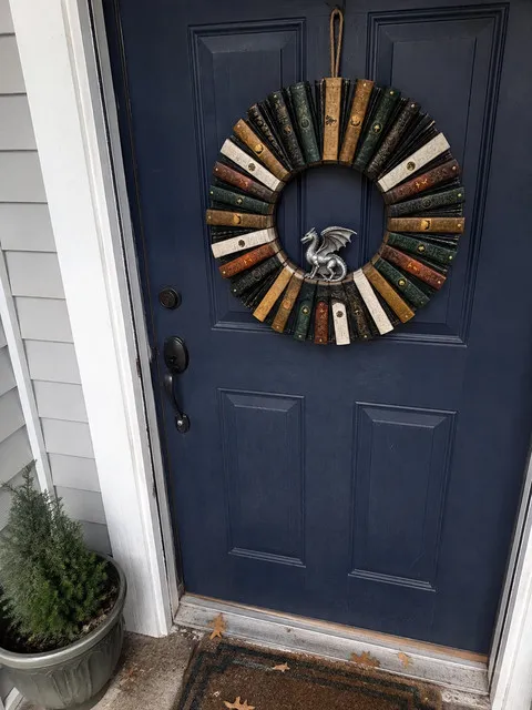 Vintage Dragon book wreath on a navy front door