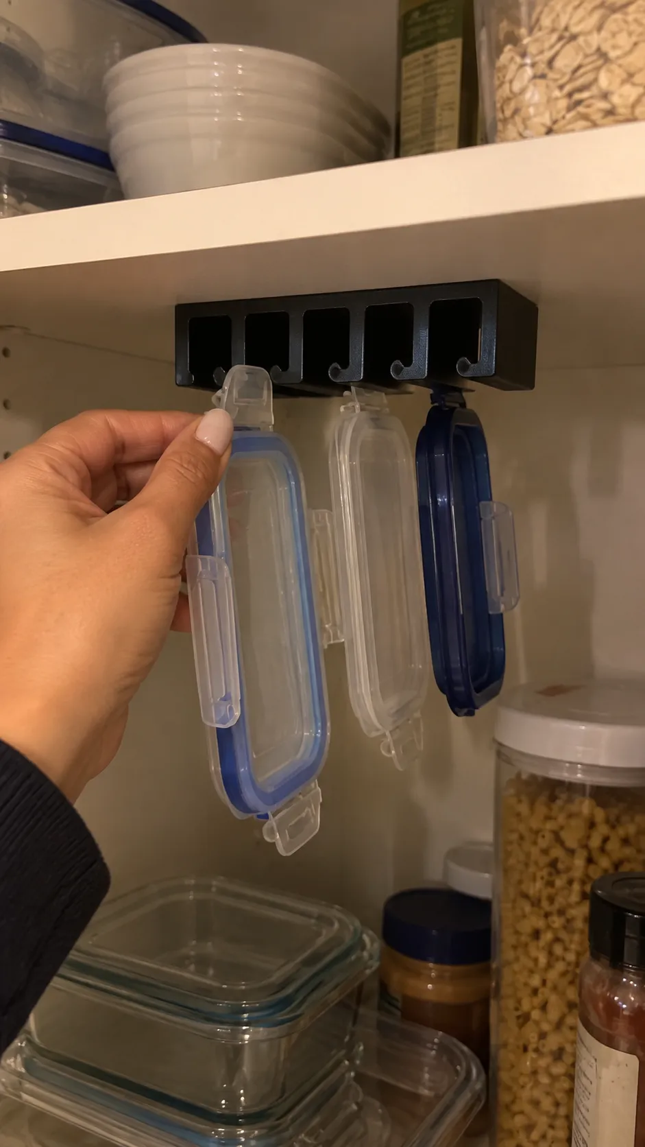 Black lid organizer in an apartment cabinet