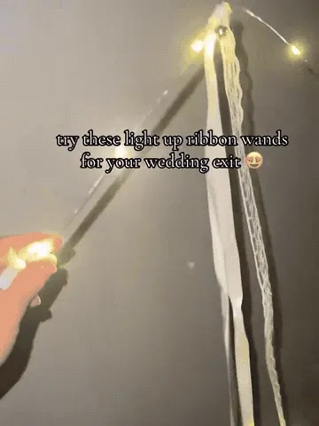 Warm white LED ribbon fairy wand glowing while being waved