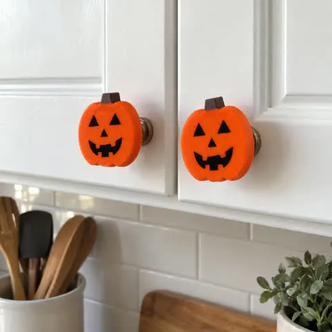 Pumpkin accents on white kitchen cabinet knobs