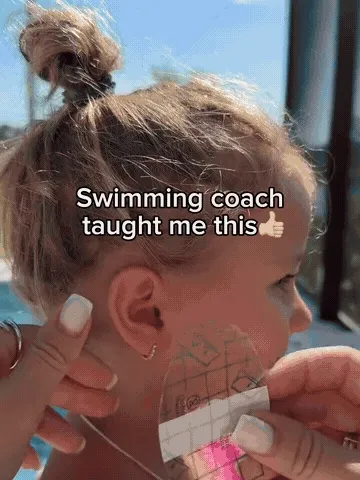 Applying a waterproof ear cover before swimming
