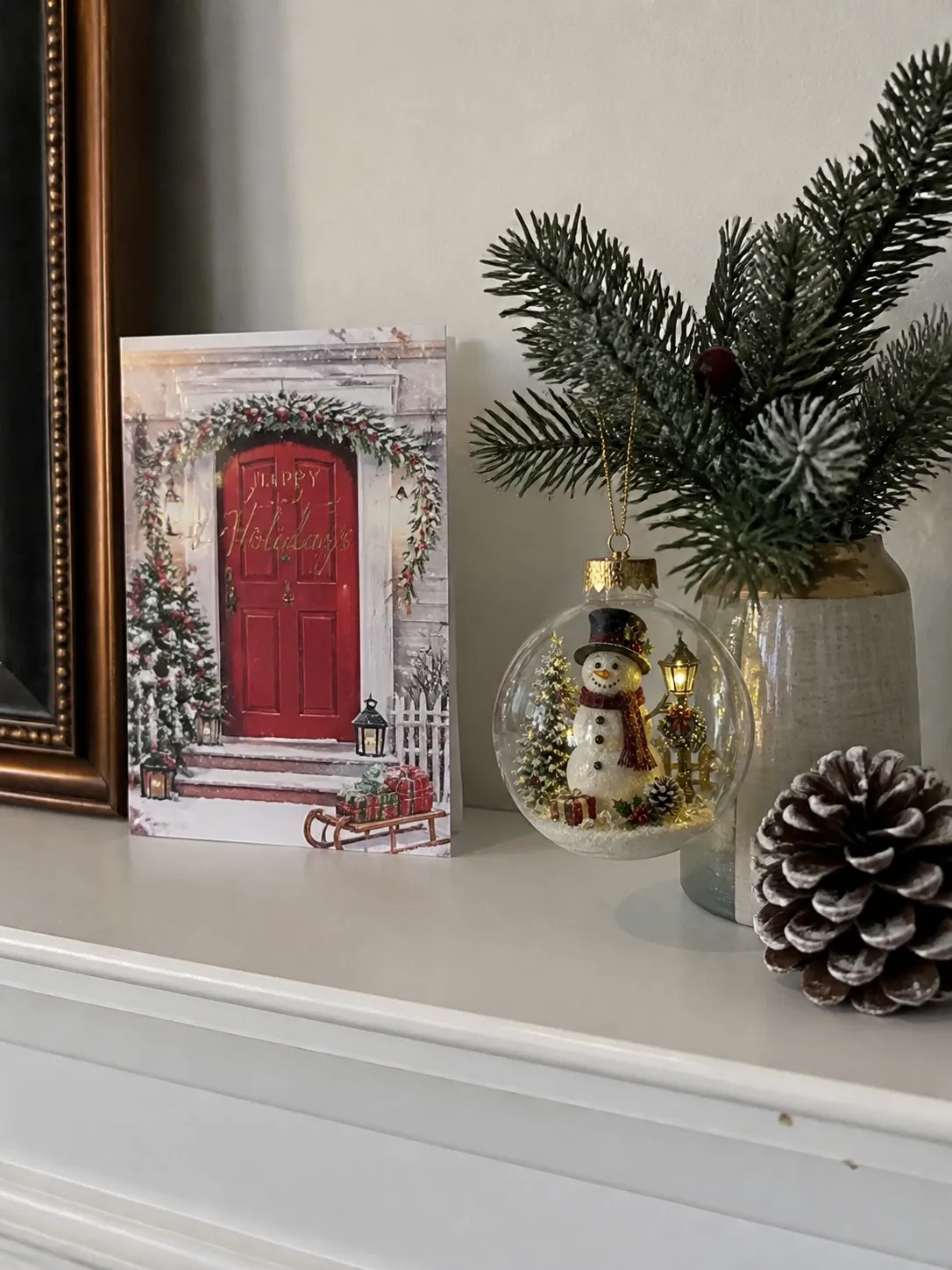 Snowman ornament displayed on a bright mantel