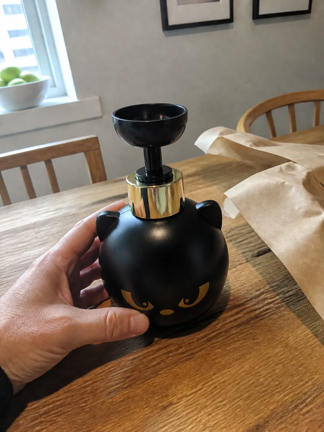 Cat dispenser being unwrapped on a dining table