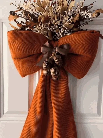 Autumn bow being shaped and styled on a door