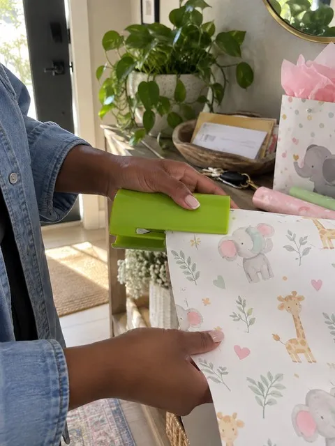 Lime green wrapping paper cutter used for baby-shower gift wrap