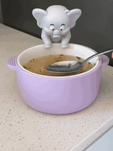 Elephant fan clipped to a bowl while food is stirred