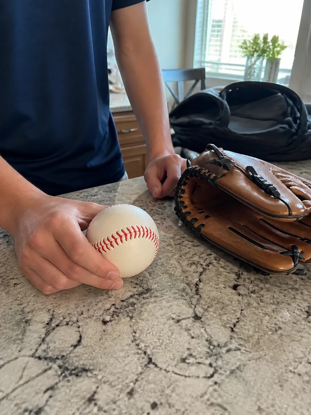 Baseball ready for an afternoon game on a kitchen counter