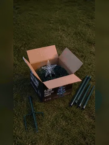 The solar spiral Christmas tree light being assembled, shaped, and illuminated outdoors