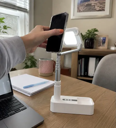 Phone stand being set up at a home-office desk