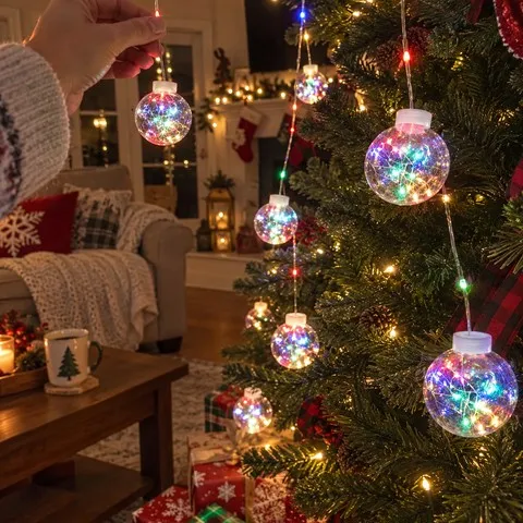 Multicolor crackle globe lights being adjusted on a family Christmas tree