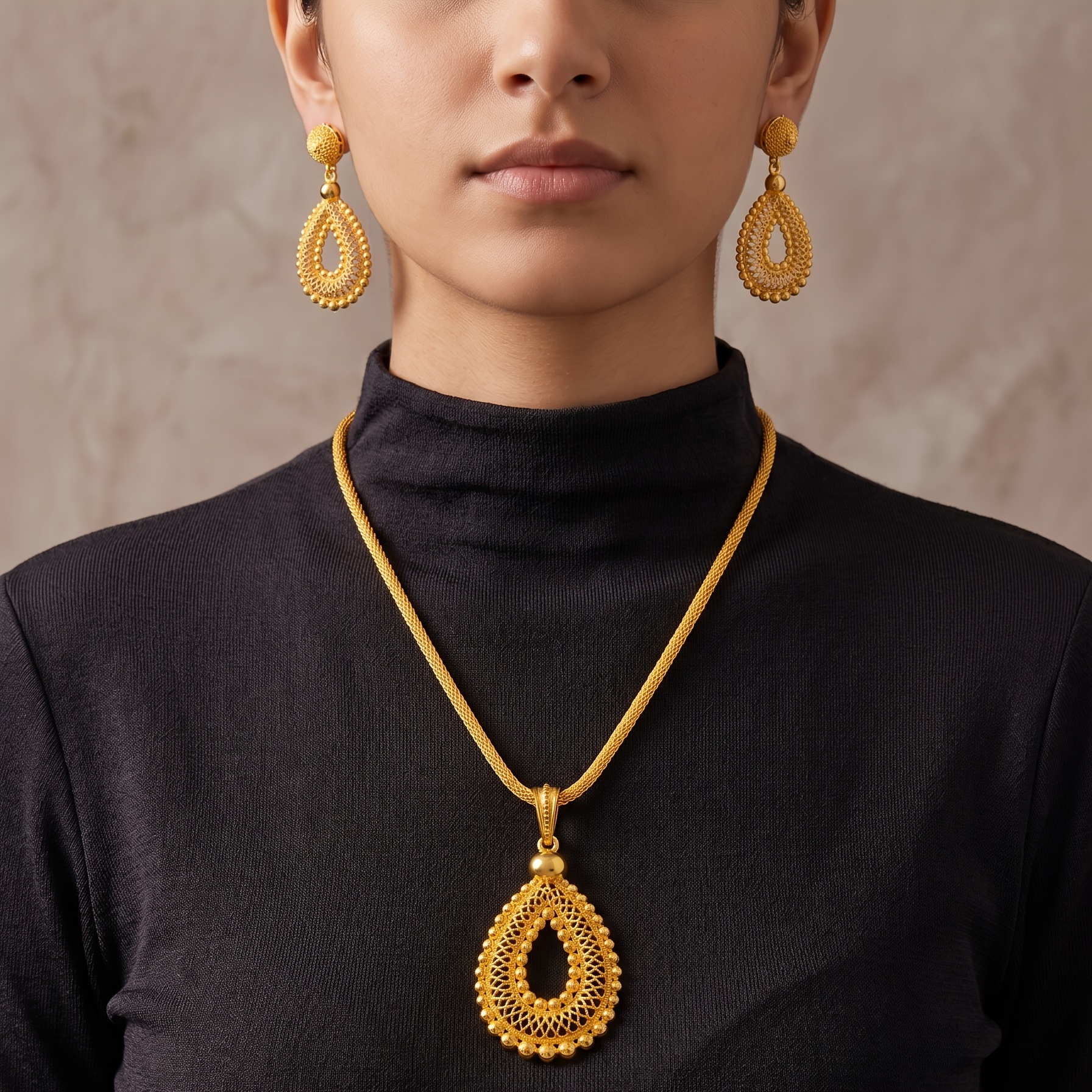 Gold-tone pierced teardrop necklace & earring set, front view