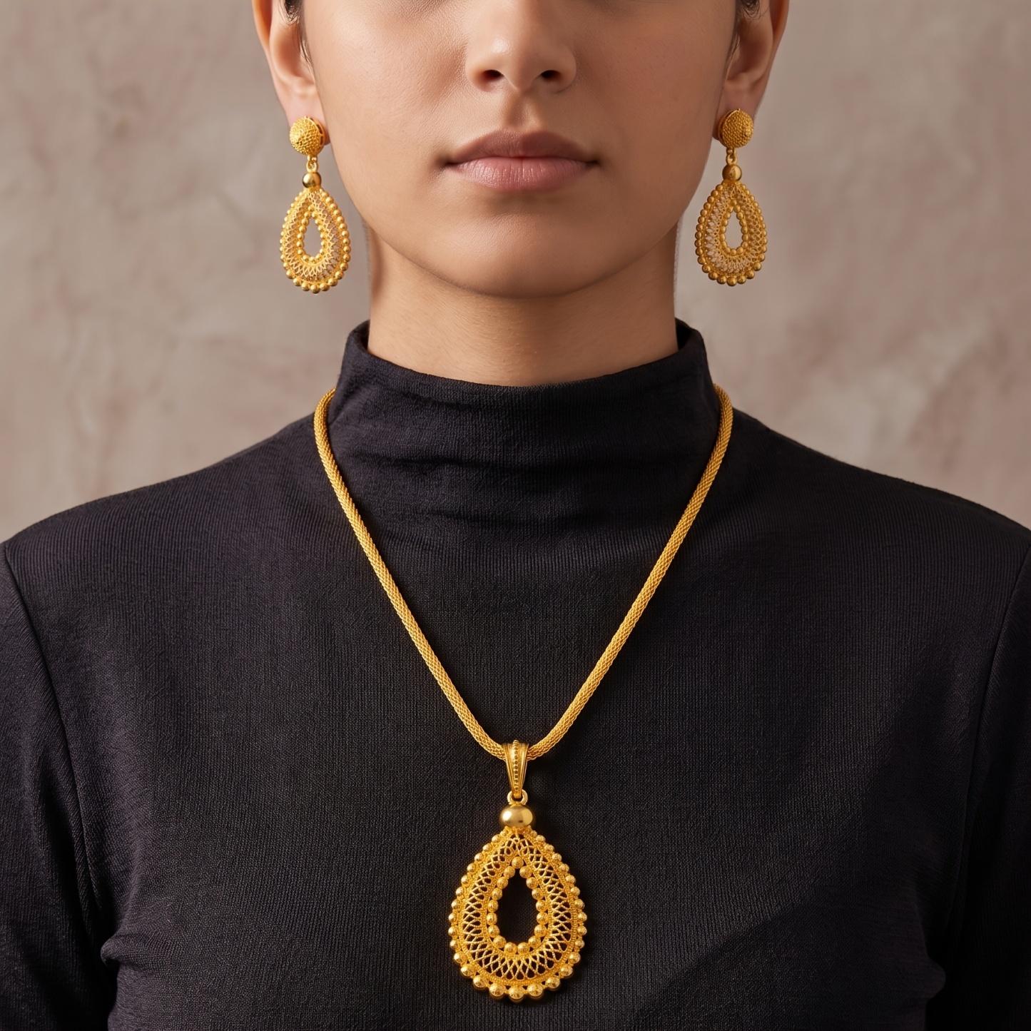 Gold-tone pierced teardrop necklace & earring set, front view