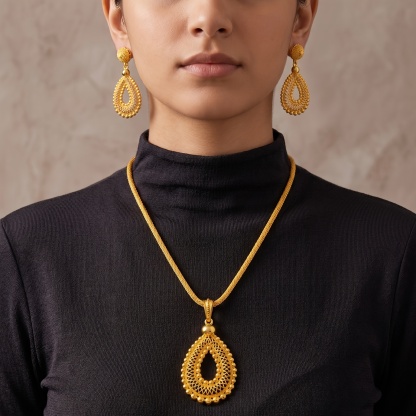 Gold-tone pierced teardrop necklace & earring set, front view