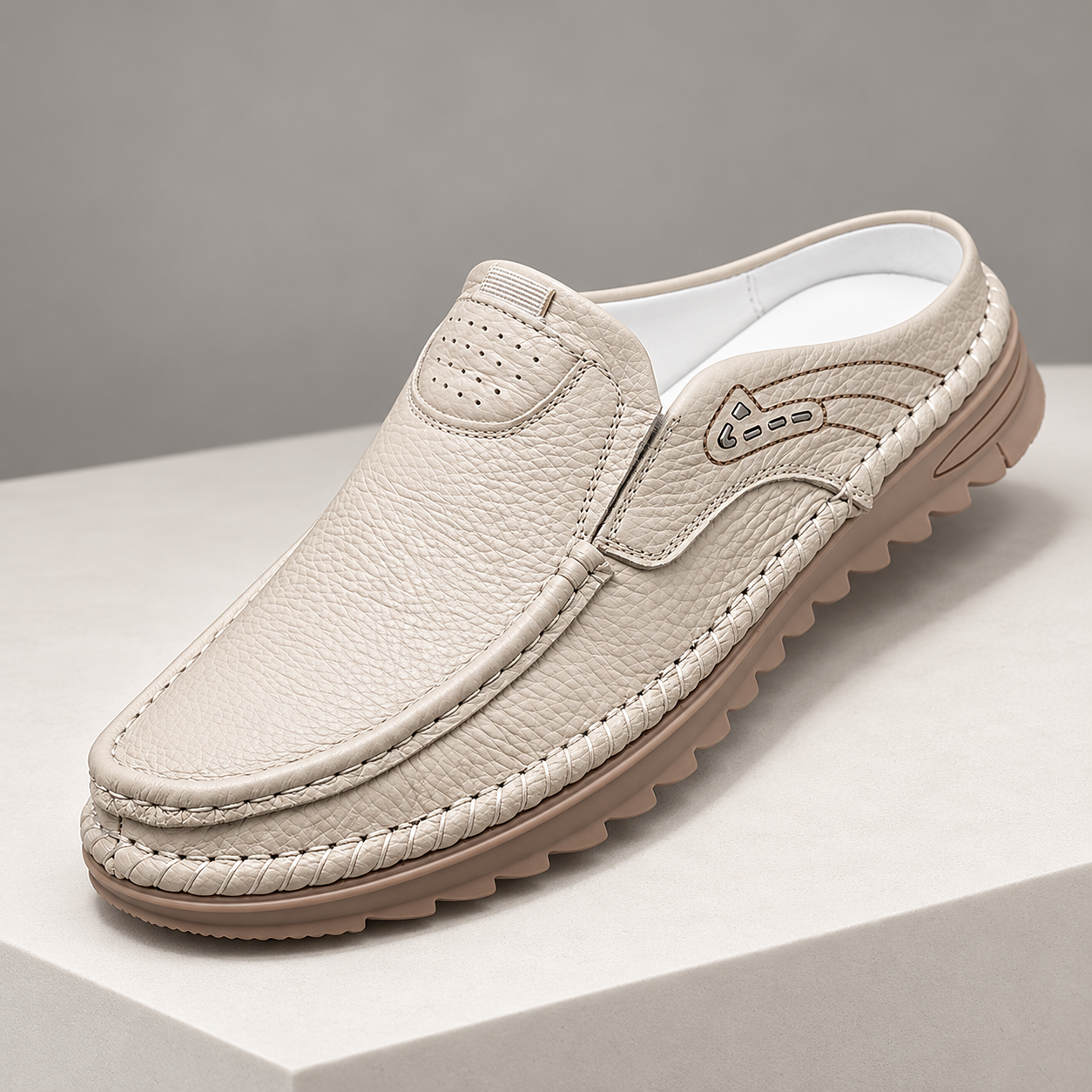 Cedar ivory backless mule showing the closed moc-toe front and open heel.