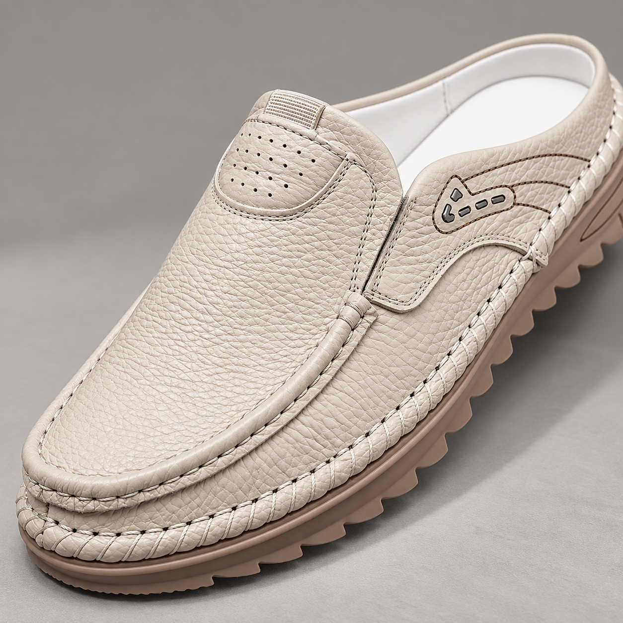 Close-up of Cedar's ivory textured upper, perforated patch and perimeter stitching.