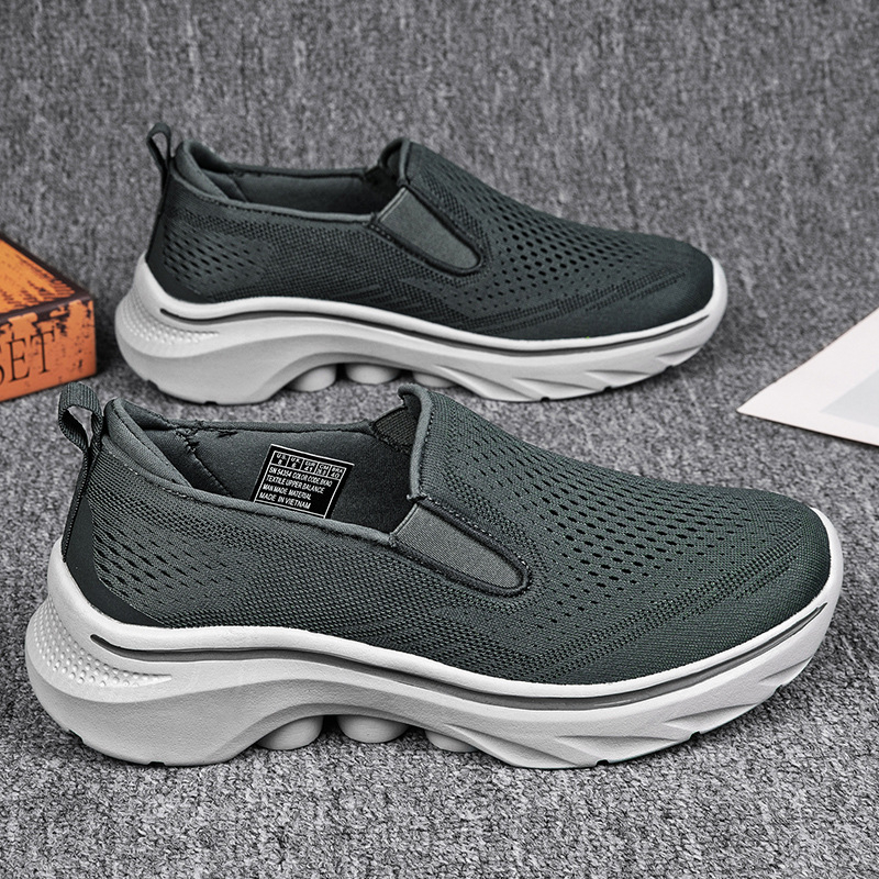 Dark Gray Motion mesh slip-on sneakers with elastic side gores.