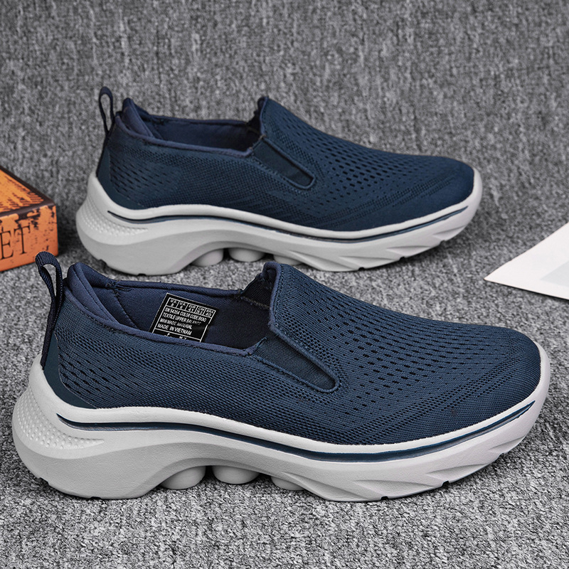 Navy Motion mesh slip-on sneakers with fully enclosed heels.