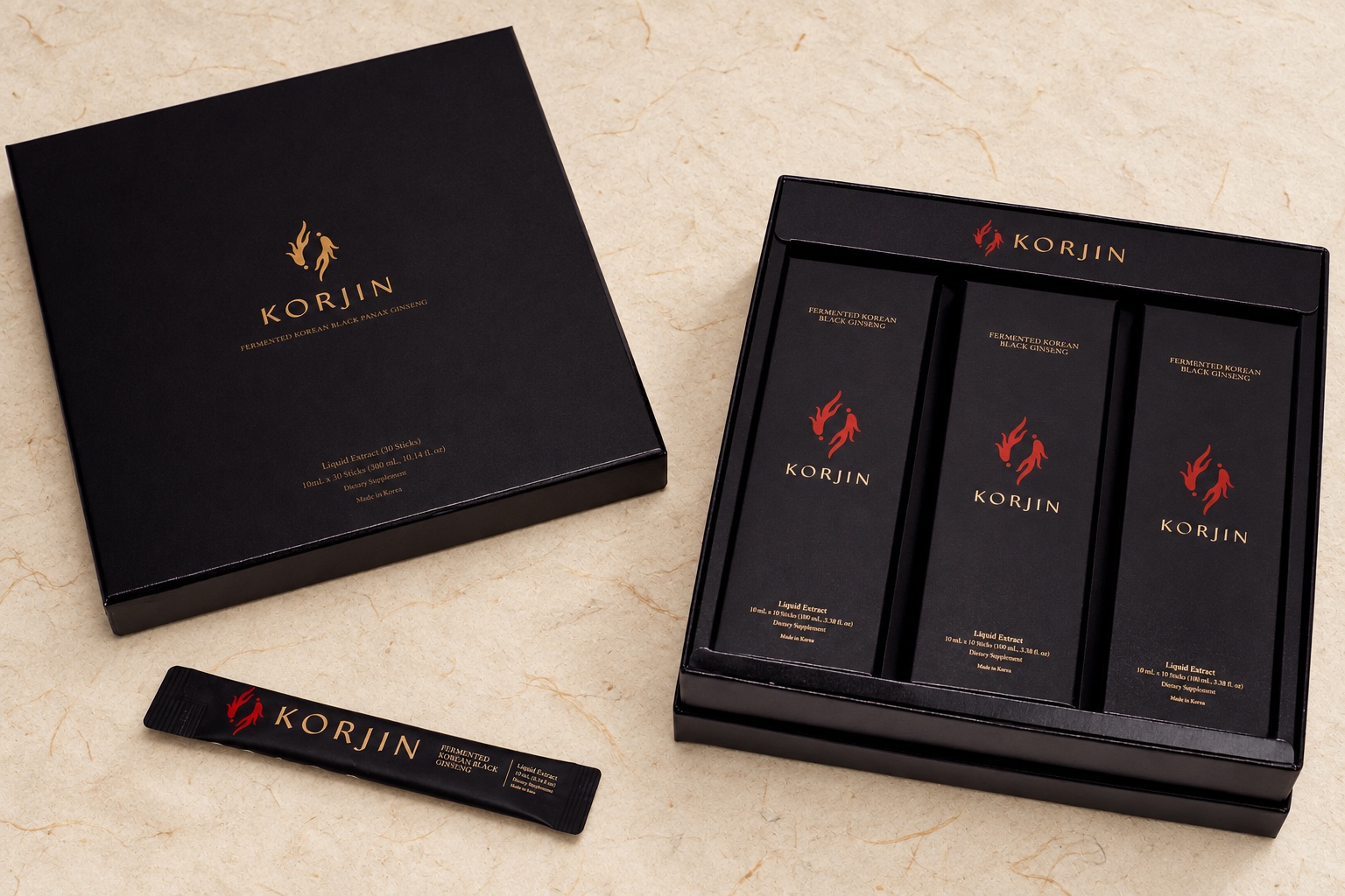 A closed Korjin 30-pack beside its open tray of three 10-stick boxes and a stick, on hanji paper