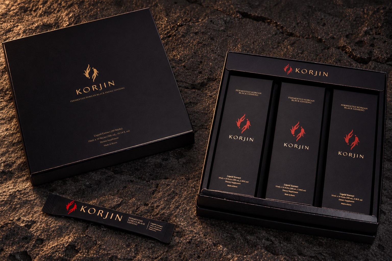 A closed Korjin 30-pack beside its open tray of three 10-stick boxes, with a single stick, on dark stone