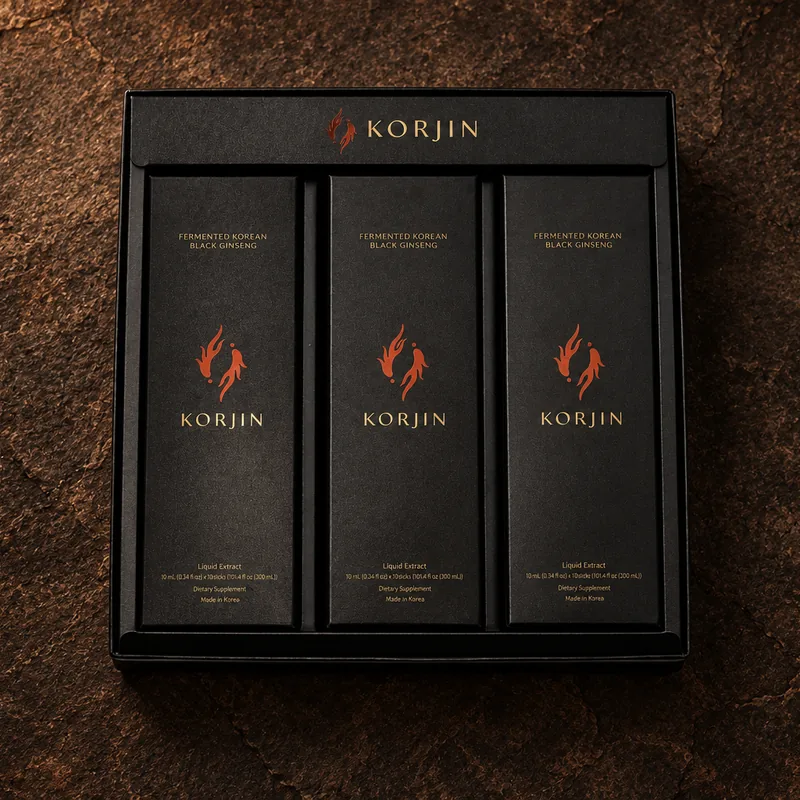 An open Korjin 30-pack from above: three inner boxes of ten sticks on dark stone