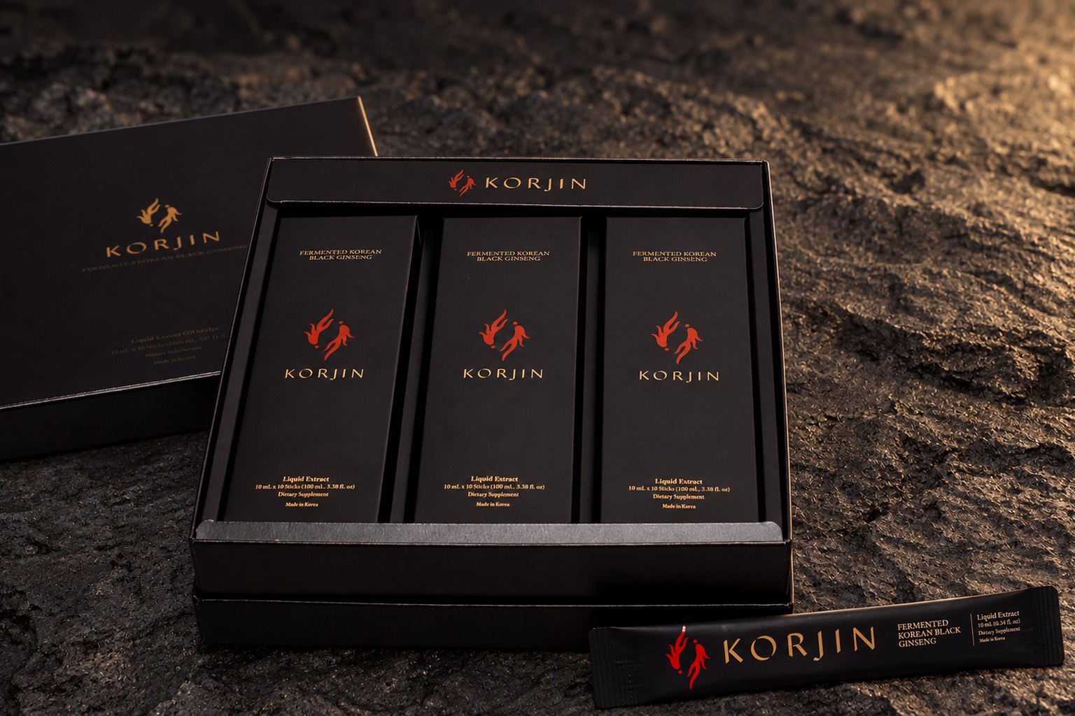 A Korjin 30-pack open on dark stone: the lid beside it, three boxes of ten sticks inside, and one stick