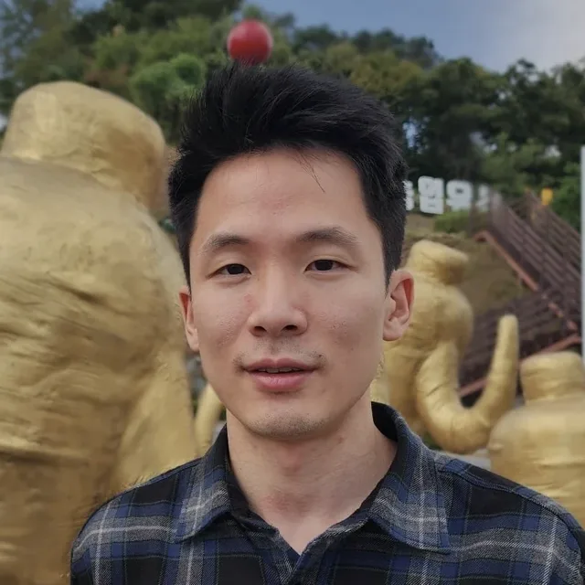 Justin H. Chung among the golden ginseng sculptures in Geumsan