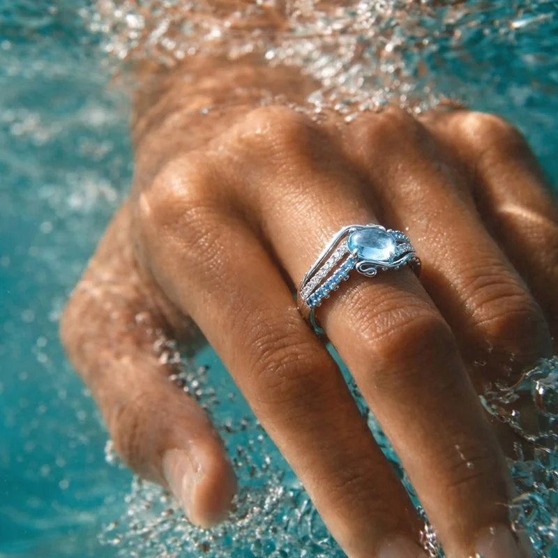 Jeulia Bypass Ocean Wave Oval Blue Topaz Engagement Ring